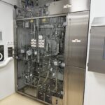 Sterile filtration skid of the Cooptech formulation system behind glazed guarding