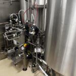 Cooptech formulation skid alongside a jacketed storage tank