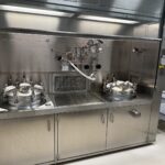 Cooptech formulation vessels installed under a stainless steel fume hood