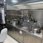 Formulation vessels under fume hood with local operator panel