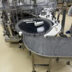 Rotary table and transfer conveyor of the OPTIMA WMR 2400 vial washing machine