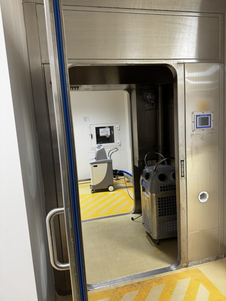 Bioquell WIC-1 walk-in pass-through chamber with the door open, Clarus L2 generator and catalytic aeration unit inside
