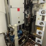 Service area of the Getinge sterilizer with vacuum pump, control cabinet and valve panel